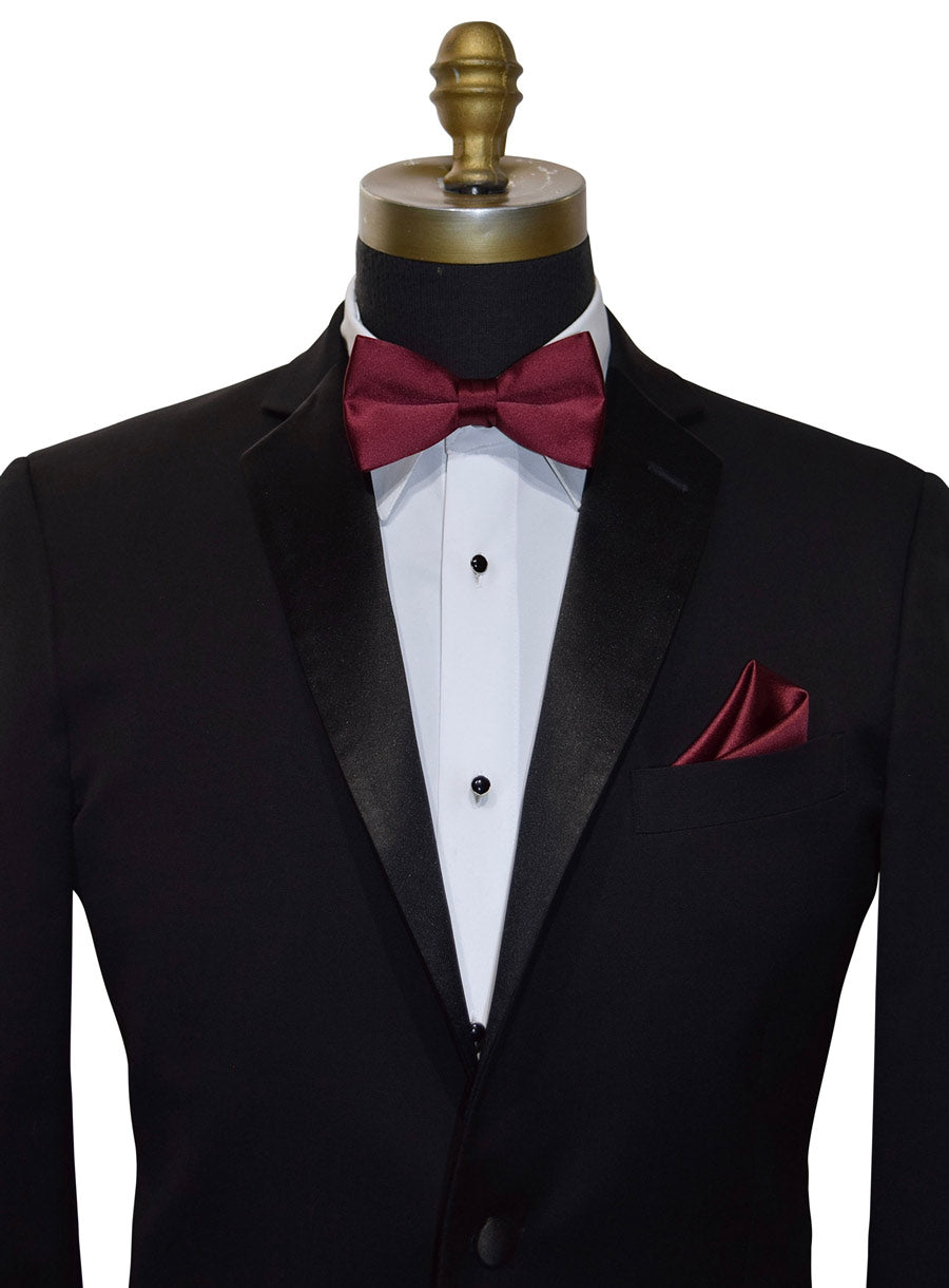 Close up photo of a black notch lapel tuxedo with a burgundy bowtie and pocket handkerchief