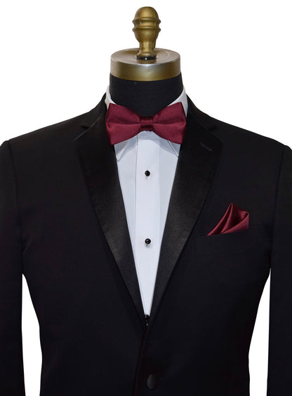 Close up photo of a black notch lapel tuxedo with a burgundy bowtie and pocket handkerchief