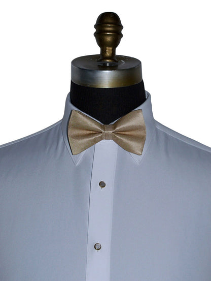 white dress shirt with a golden "pre-tied"  bow tie on a mannequin against a white background