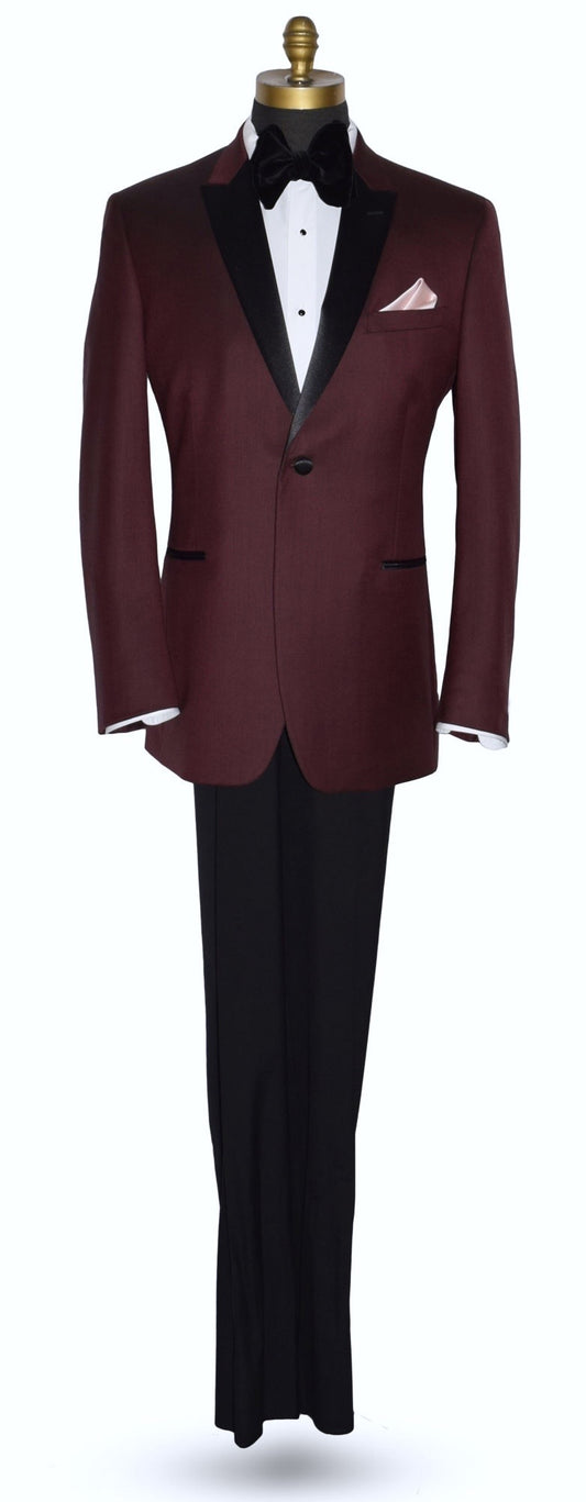 burgundy tuxedo with black peak lapels shown with white tuxedo shirt and black bowtie on a mannequin against a white background
