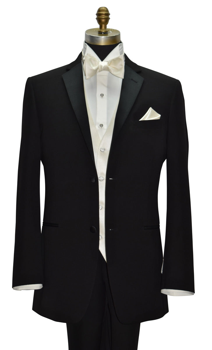 close-up mannequin wearing a black notch-lapel tuxedo with an ivory tuxedo shirt and an off-white tuxedo vest and bowtie against a white background