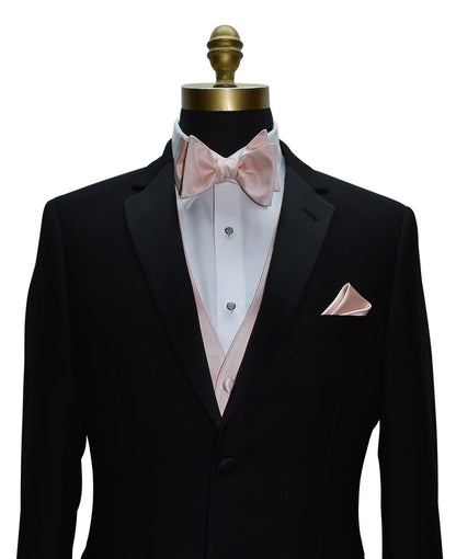close-up Black tuxedo with blush "tie-yourself" bow tie and pocket square on a mannequin against a white background