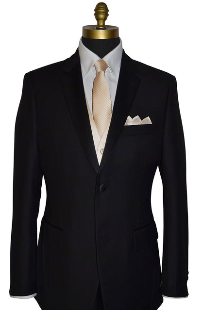 black notch-lapel tuxedo wearing a champagne colored necktie with subtle champagne stripe with a matching champagne pocket handkerchief