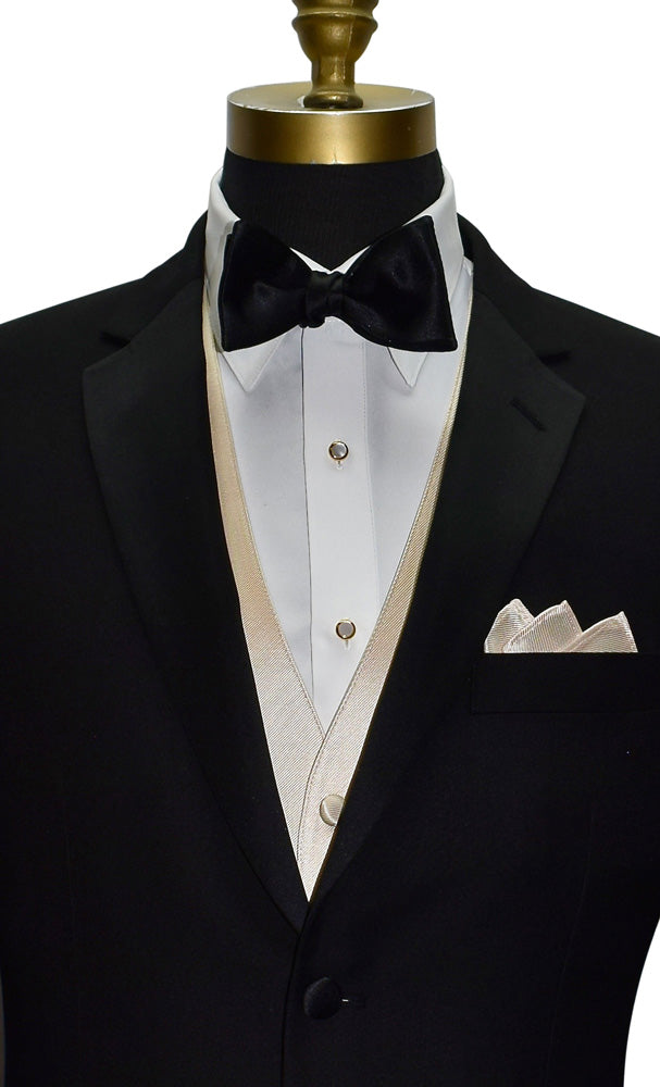black notch lapel tuxedo with white tuxedo shirt and a champagne tuxedo vest with a black satin bowtie against a white background 