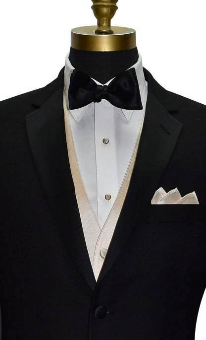 black notch lapel tuxedo with white tuxedo shirt and a champagne tuxedo vest with a black satin bowtie against a white background 
