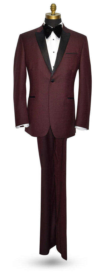 Burgundy tuxedo with black lapels wearing a large butterfly-bowtie on a mannequin against a white background
