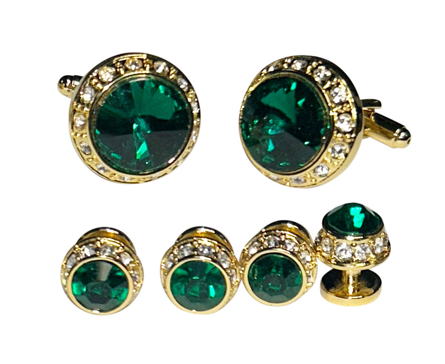Gold cufflinks and studs with emerald green gemstones and crystals on a white background