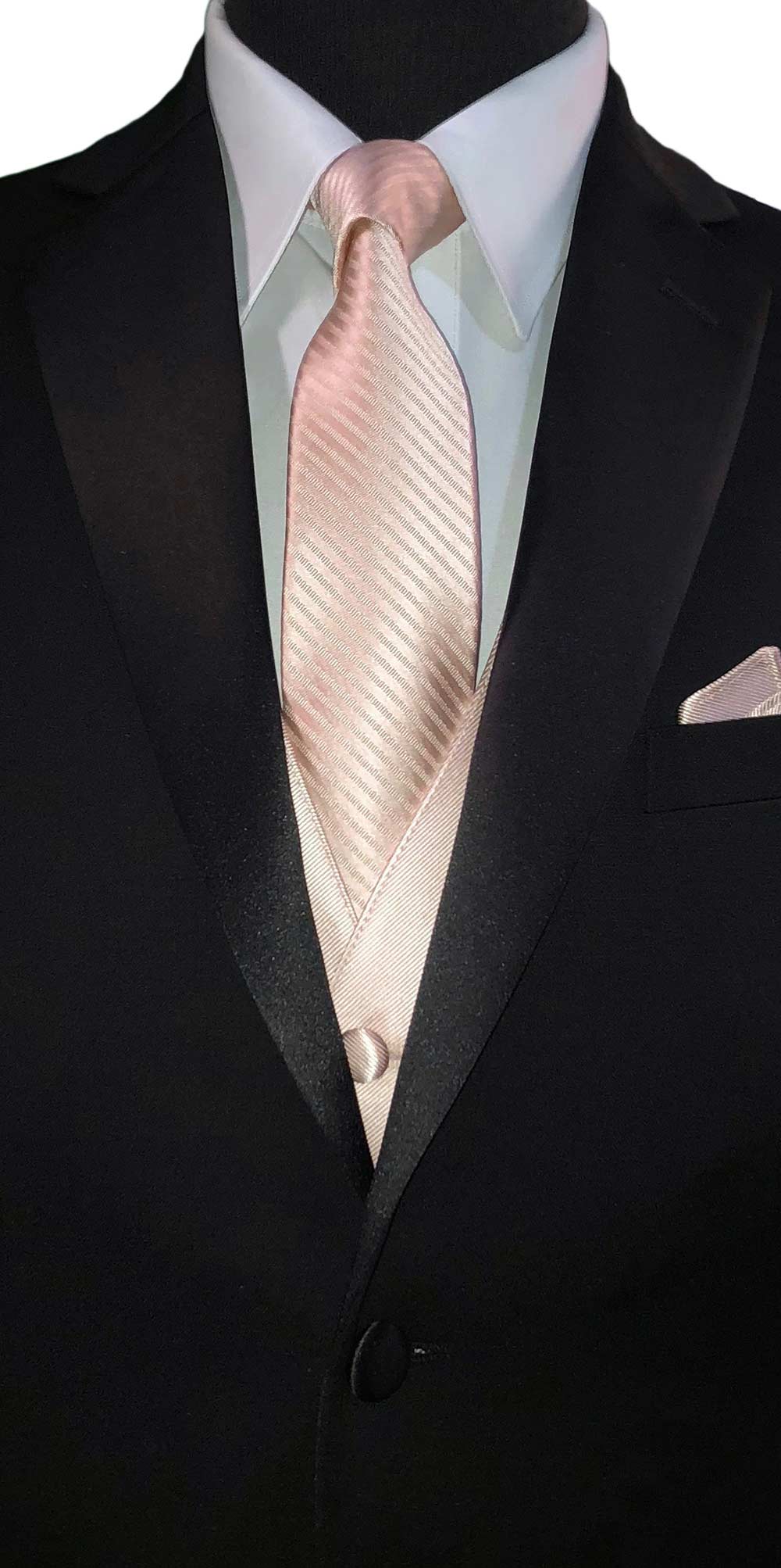 close-up black notch-lapel tuxedo with a white dress shirt with a petal tuxedo vest and petal necktie and pocket handkerchief against a white background