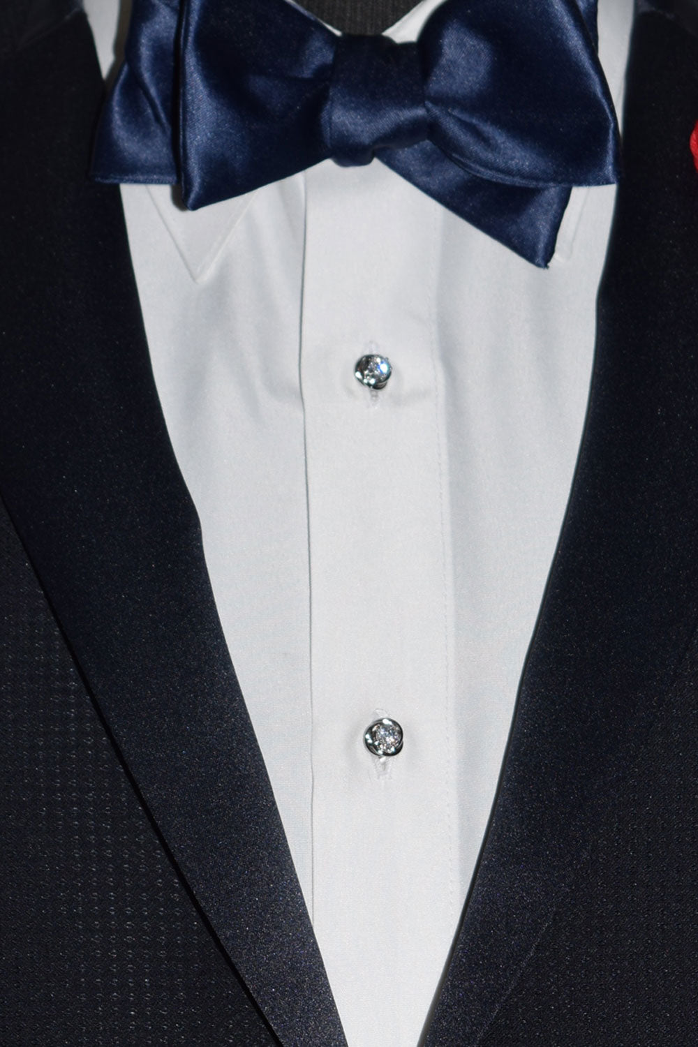 very close-up  midnight-blue tuxedo with a blue-satin tie-yourself bowtie and crystal studs and cufflinks