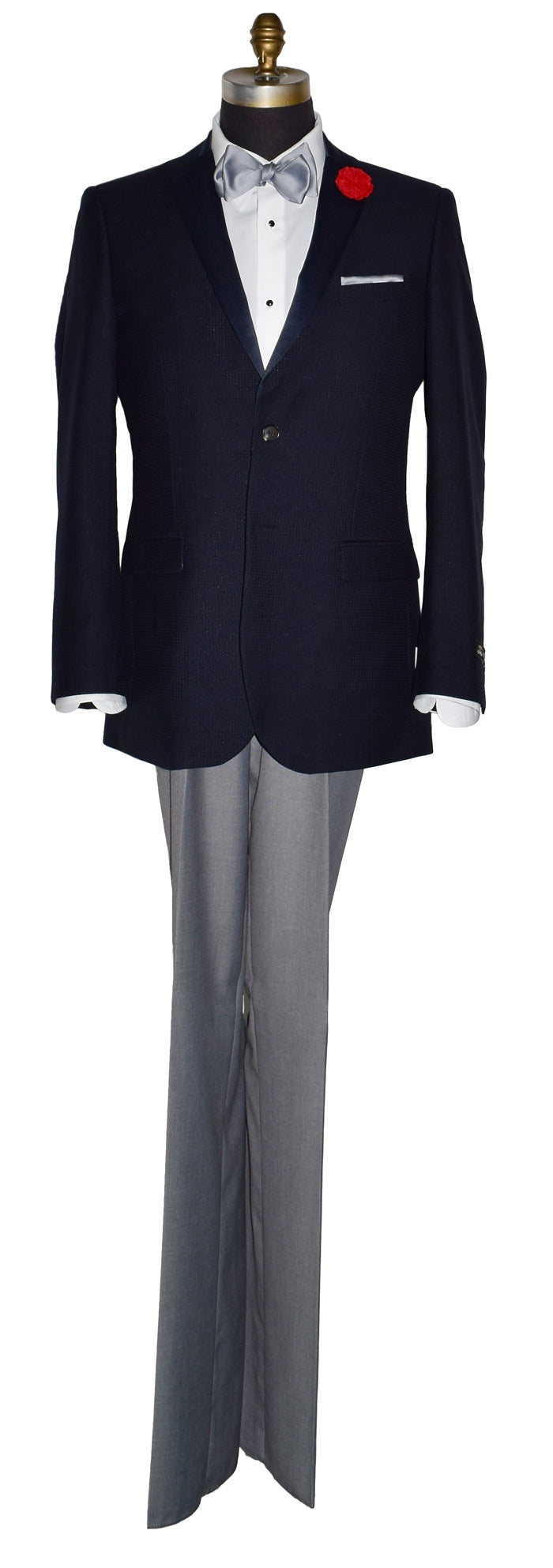 midnight blue tuxedo jacket on a mannequin with a silver-gray tie-yourself bowtie and light gray tuxedo pants against a white background