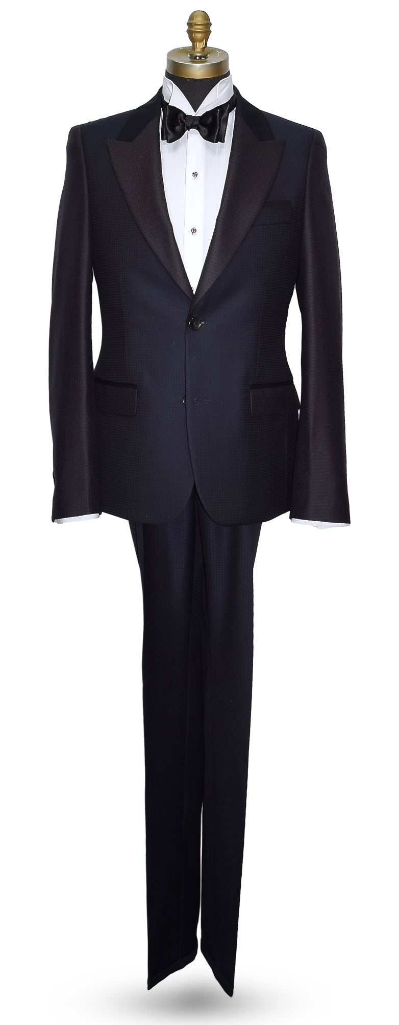 life size mannequin wearing a navy blue peak lapel tuxedo on a mannequin against a white background
