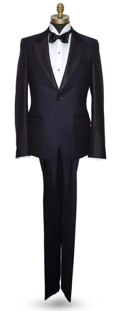 life size mannequin wearing a navy blue peak lapel tuxedo on a mannequin against a white background