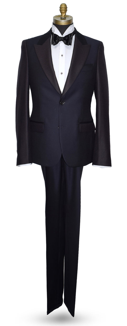 life size mannequin wearing a navy blue peak lapel tuxedo on a mannequin against a white background