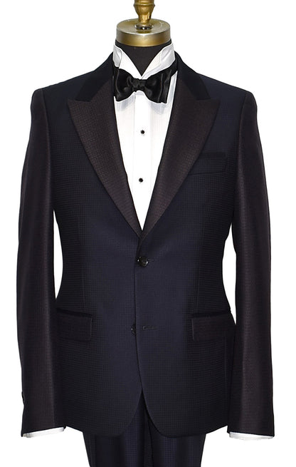 close-up navy-blue peak lapel tuxedo with white shirt and black bow tie on a mannequin against a white background