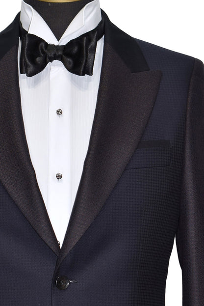 navy-blue peak lapel tuxedo with white shirt and black bow tie on a mannequin with silver love-knots formal jewelry
