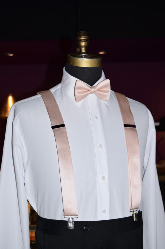 side view mannequin wearing a white dress shirt with petal satin suspenders and petal bow tie in a tuxedo shop