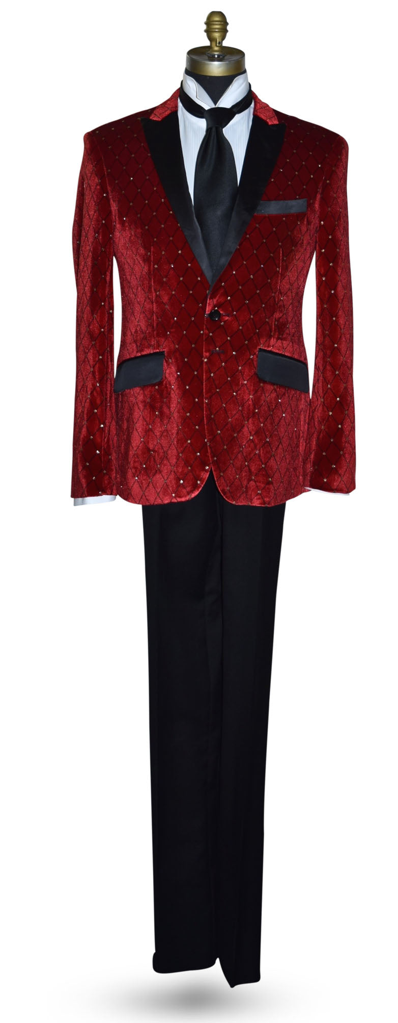 Red velvet tuxedo with black lapels and pants with a long black satin necktie on a mannequin against a white background