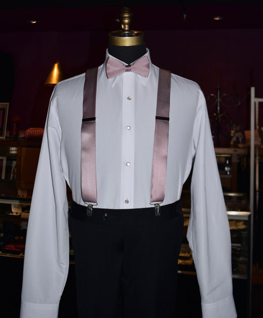 Mannequin wearing a white dress shirt with quartz satin suspenders and a bow tie in a tuxedo shop.