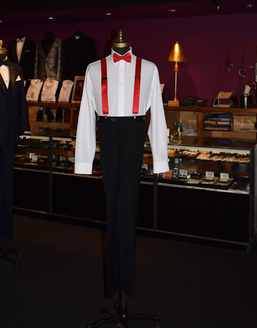 full length mannequin wearing a white shirt with a red bow tie and red satin suspenders in a store setting.