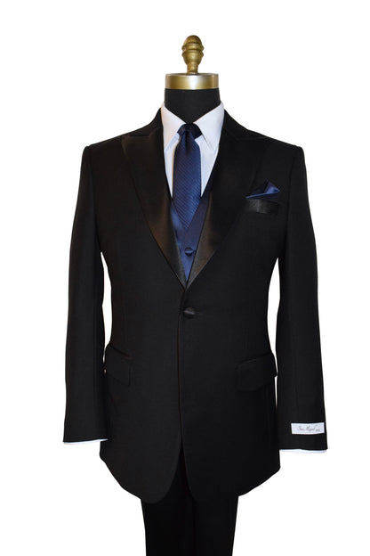 Black peak lapel tuxedo with a blue necktie tie and vest on a mannequin against a white background