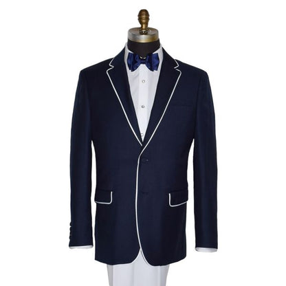 close up Versace Navy suit with white pants and a nay bowtie against a white background
