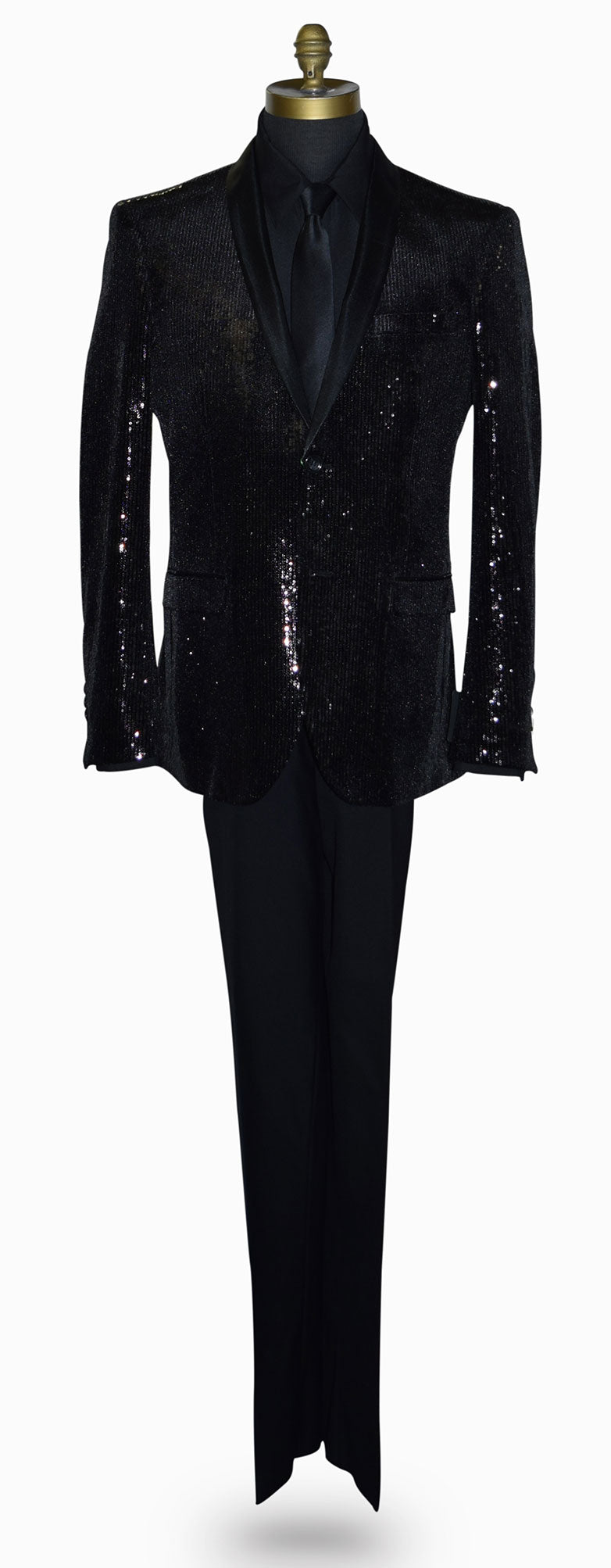 life size mannequin wearing a black sequin shawl collar tuxedo with a black shirt and black necktie against a white background