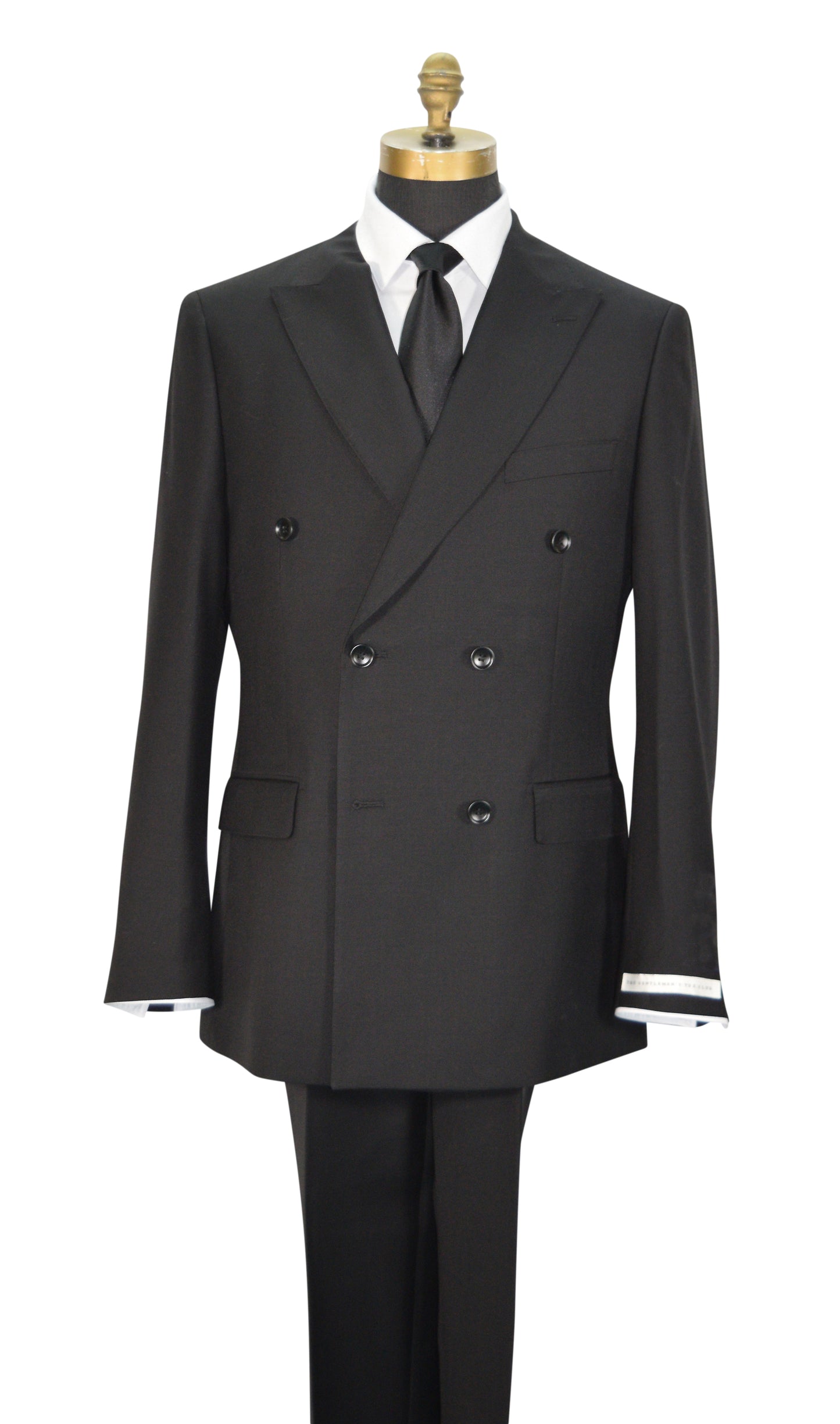 A black double-breasted men's suit displayed on a mannequin torso with a white dress shirt, black necktie, and black trousers. The jacket features peak lapels, six buttons, flap pockets, and super lightweight tropical wool.
