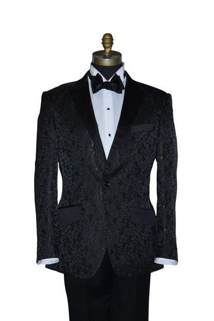 Black brocade tuxedo wearing a white shirt and black bow tie on a mannequin against a white background