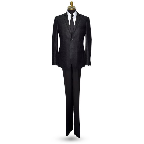 A black brocade tuxedo with satin trim on the notch lapel, displayed on a mannequin.