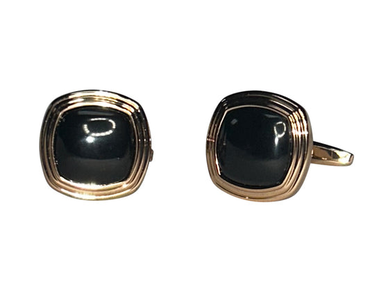 Pair of black stone cufflinks in a rose-gold setting against a white background