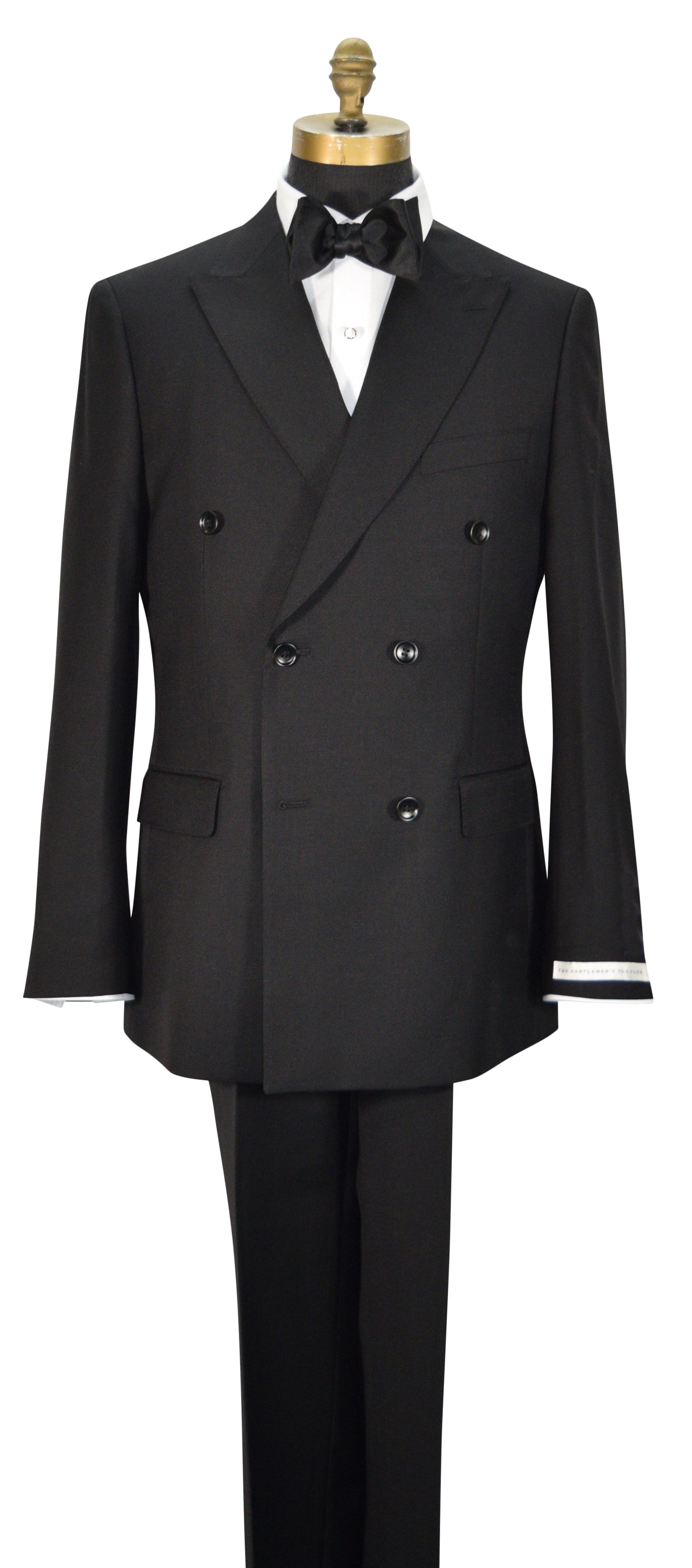 close-up mannequin wearing black double-breasted men's suit displayed on a mannequin torso with a white dress shirt, black bowtie, and black trousers. The jacket features peak lapels, six buttons, flap pockets, and super lightweight tropical wool.
