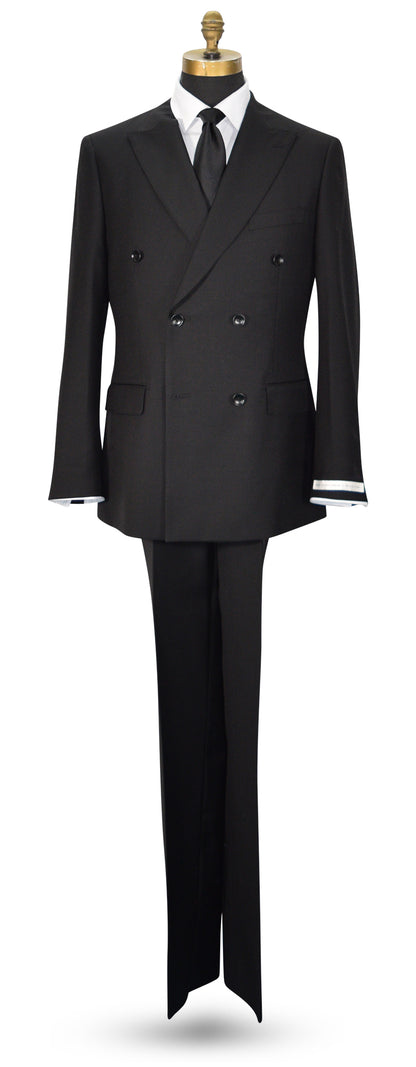 life size mannequin wearing a black double-breasted men's suit displayed with a white dress shirt, black necktie, and black trousers. The jacket features peak lapels, six buttons, flap pockets, and super lightweight tropical wool.