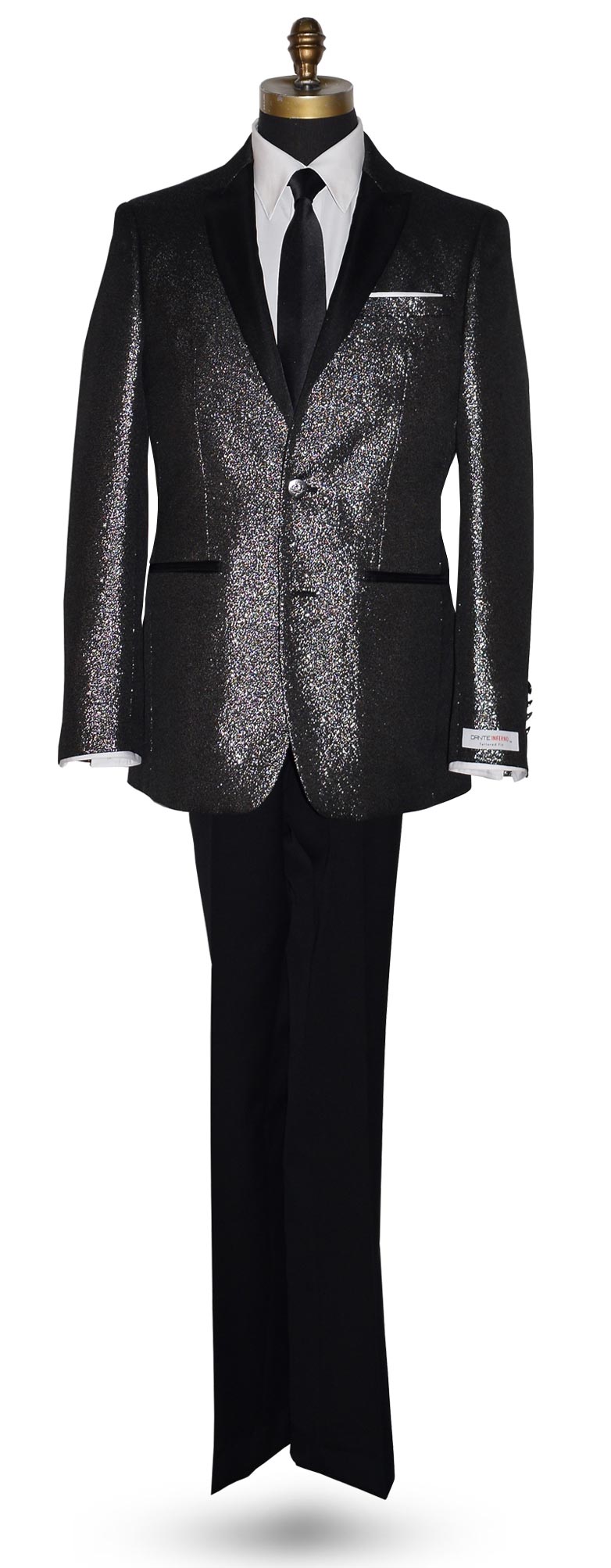 full length mannequin wearing a black peak lapel tuxedo with shimmer accessorized with long black skinny dress tie with a "Dante Inferno" branded label on the sleeve against a white background
