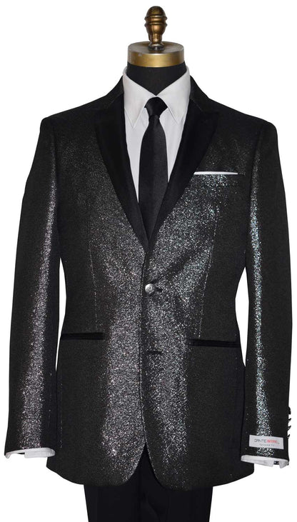 close-up full length mannequin wearing a black peak lapel tuxedo with shimmer accessorized with long black skinny dress tie with a "Dante Inferno" branded label on the sleeve against a white background