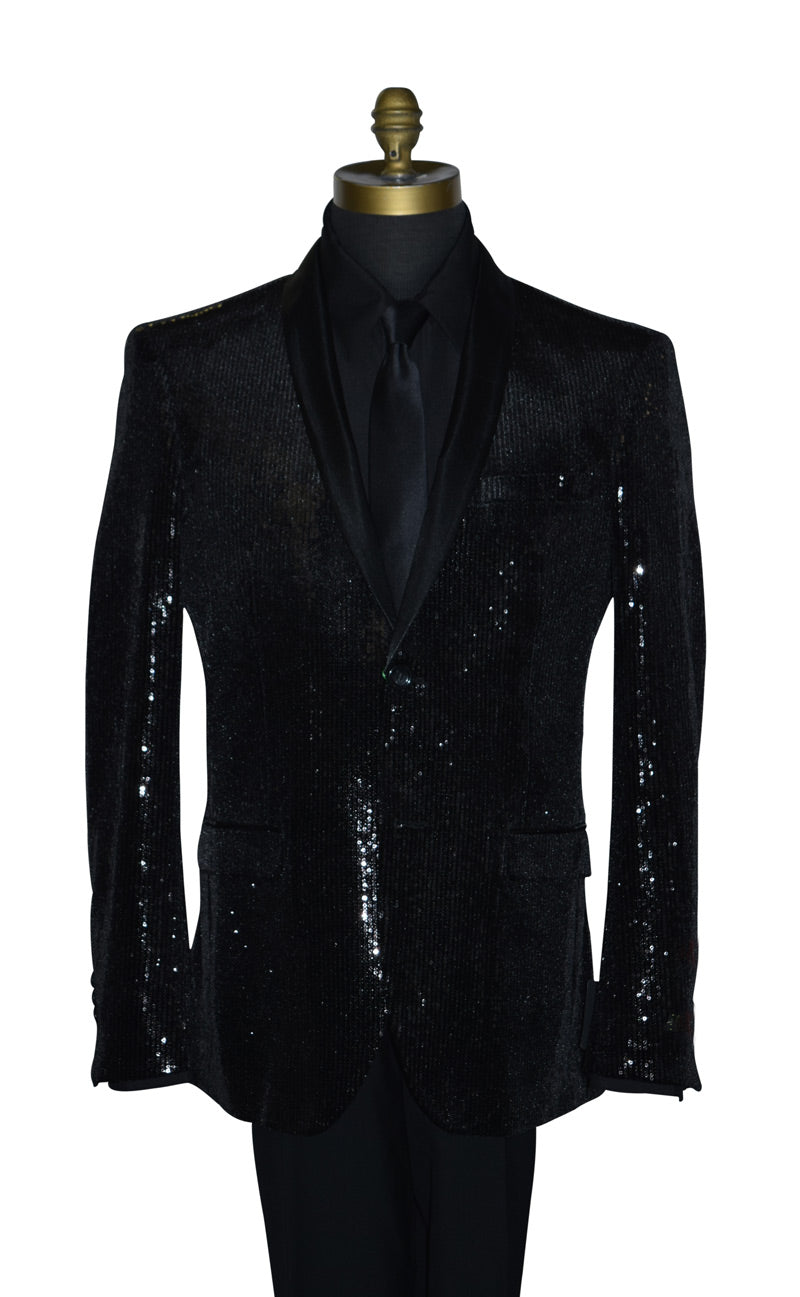 close-up life size mannequin wearing a black sequin shawl collar tuxedo with a black shirt and black necktie against a white background