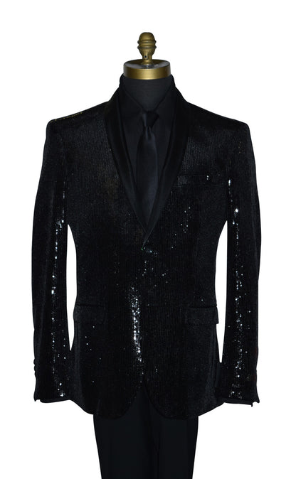 close-up life size mannequin wearing a black sequin shawl collar tuxedo with a black shirt and black necktie against a white background