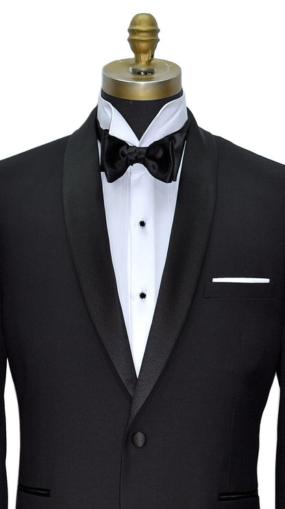 very close front view mannequin wearing a black shawl collar tuxedo with a white wing-collar tuxedo shirt and black satin bowtie on a white background