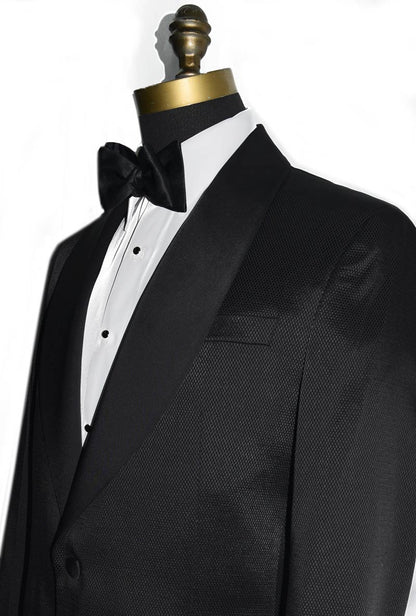 close-up size view black shawl collar tuxedo with slight texture with black satin bowtie against a white background