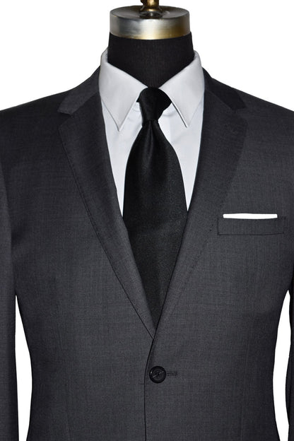 close-up Charcoal men's suit with white shirt and black silk necktie on a mannequin against a white background