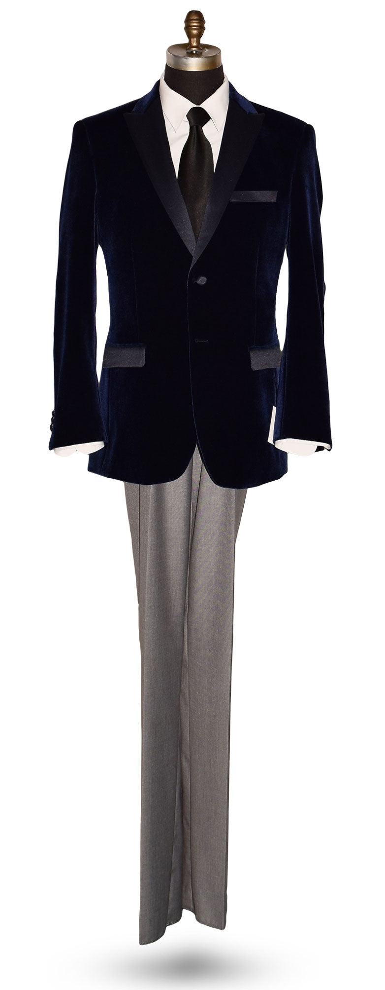 Navy blue velvet tuxedo on a mannequin with a black silk necktie against  white background