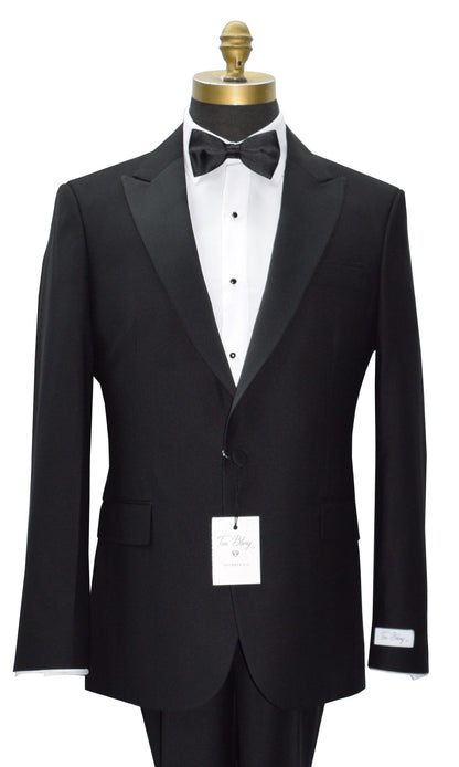 close up black 3 piece peak lapel tuxedo on a mannequin with a white tuxedo shirt and black bowtieand a "tux bling" branded label