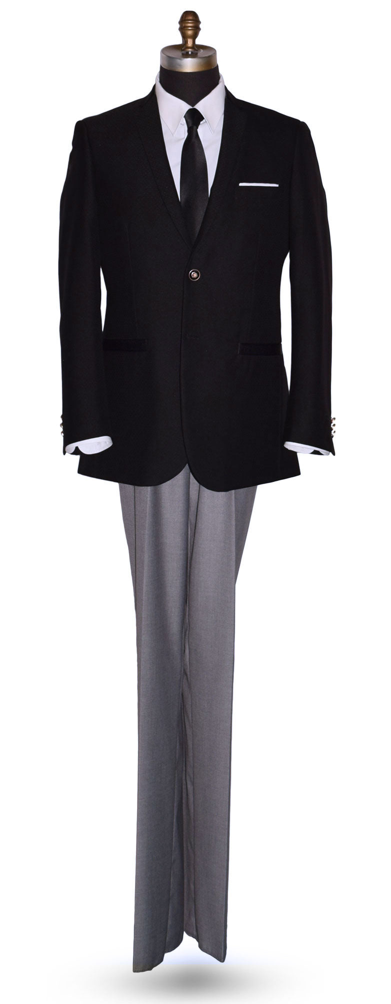 life size mannequin wearing a black sports coat with a white dress shirt and black satin necktie with gray pants in-front of a white background