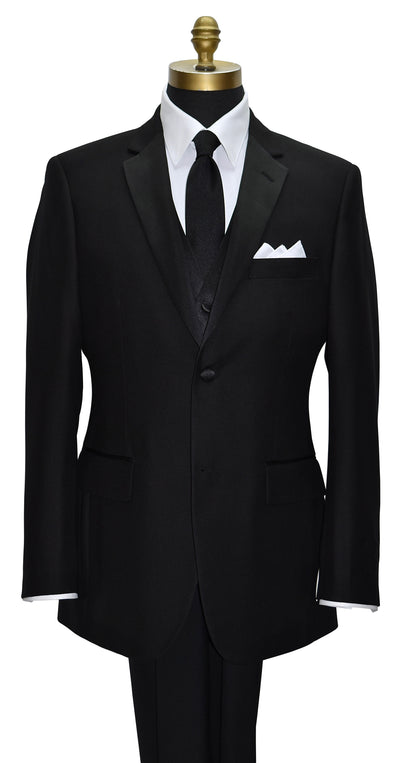 close-up black notch lapel tuxedo with a white tuxedo shirt and a long black necktie and a four-button black tuxedo vest against a white background