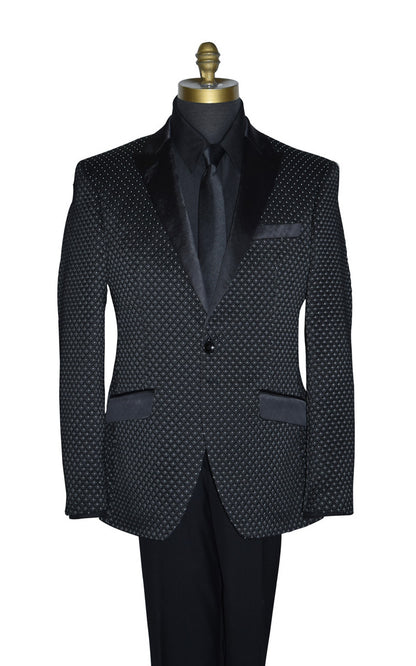 close-up Black tuxedo with white pin-dot wearing a black tuxedo shirt and long black necktie  on a mannequin against a white background