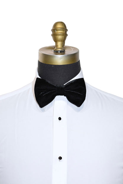 Black velvet bow tie on a white tuxedo shirt with a mannequin