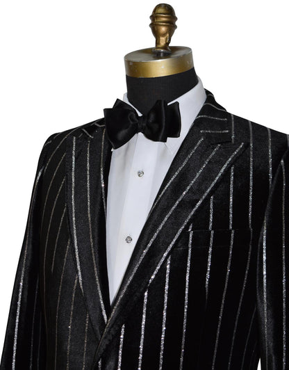 close-up side view mannequin wearing a black pinstripe suit on a mannequin with a black bow tie against a white background