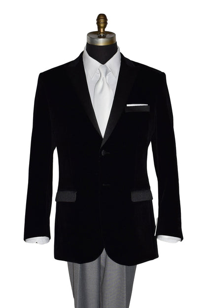 Black velvet tuxedo jacket with white shirt and a white long necktie on a mannequin against a white background