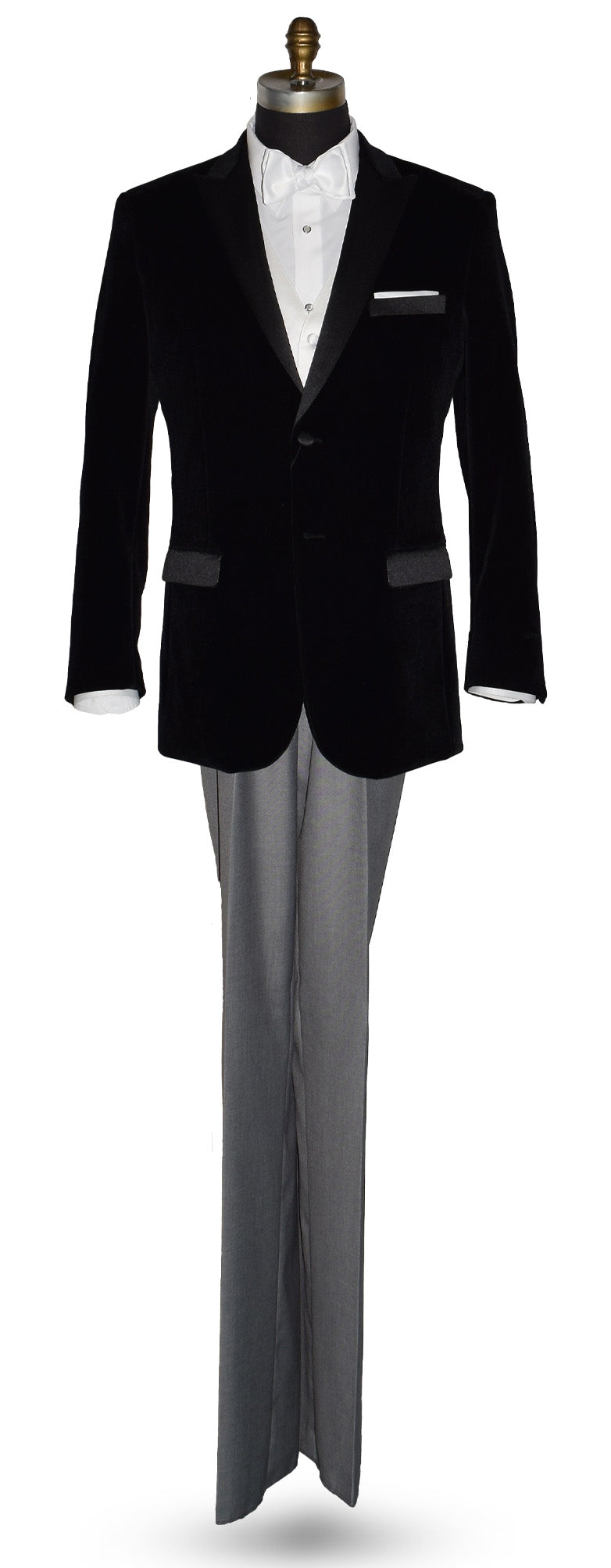 Black velvet tuxedo with white shirt and gray pants and a white satin bowtie on a mannequin against a white background