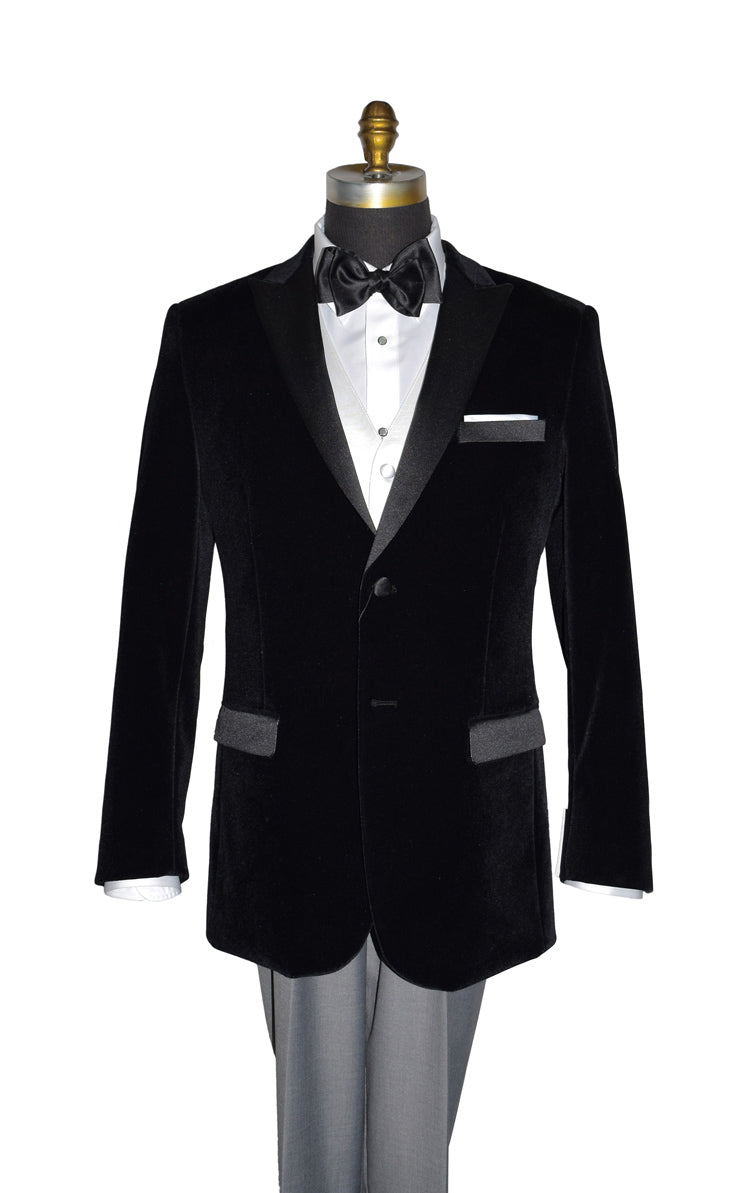 close-up  mannequin wearing black velvet tuxedo with white shirt and gray pants and a black satin tie-yourself bowtie and also a white satin vest on a mannequin against a white background