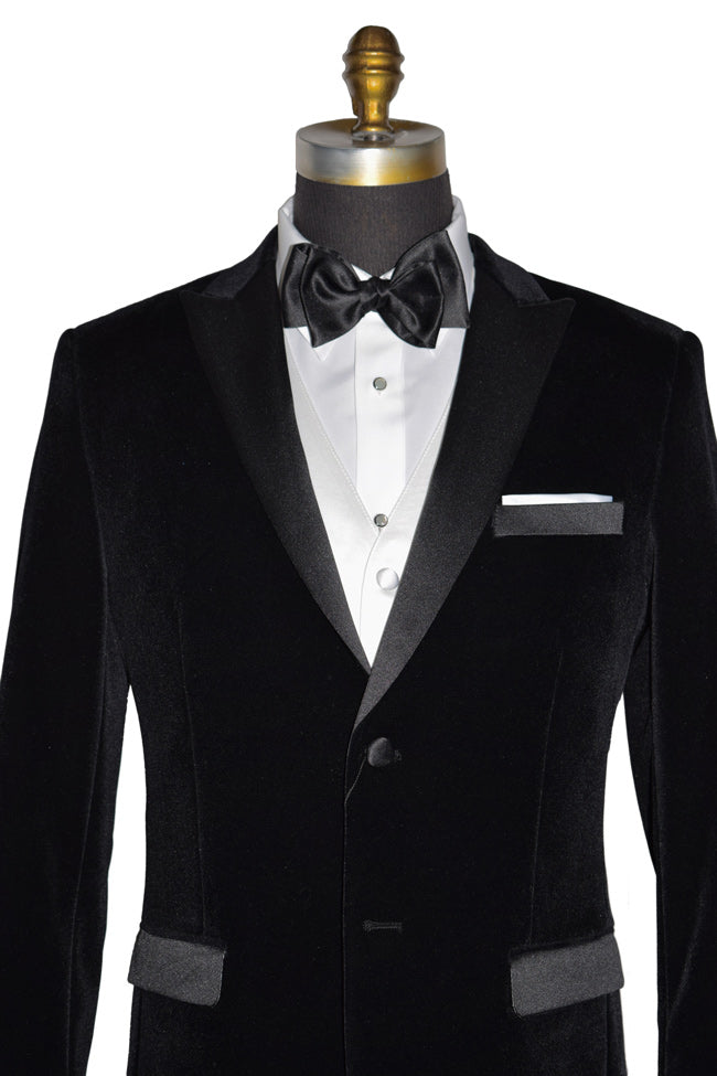 mannequin wearing a black velvet tuxedo with a white tuxedo shirt and white satin vest and a black bowtie in-front of a white background